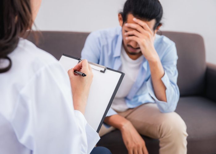 Professional psychologist woman note conducting a consultation and talk with Asian man patient